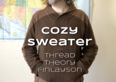 Ryan in a brown sweater, hands in the kangaroo pocket, standing in front of a map of the USA. Text overlay reads Cozy Sweater: Thread Theory Finlayson
