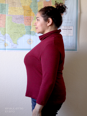 Side view of curly haired Latina woman in a red Kwik Sew 4069 turtleneck sweater, copyright Paulette Erato
