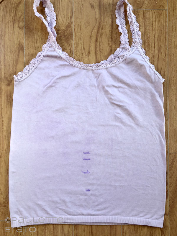 Image of a pink lace accented camisole with faint purple lines marking the waist
