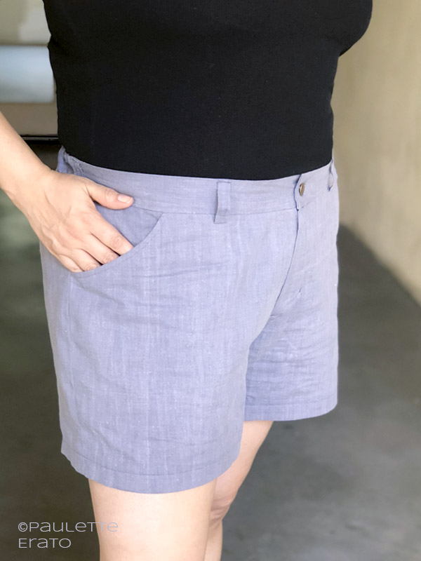 Zoomed in view of a woman's light blue Lander shorts with her hand reaching into her front side pocket