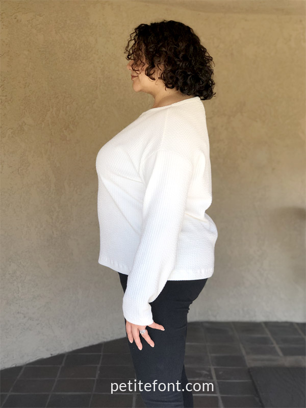 Side view of Itch to Stitch Uvita Top in ivory knit fabric