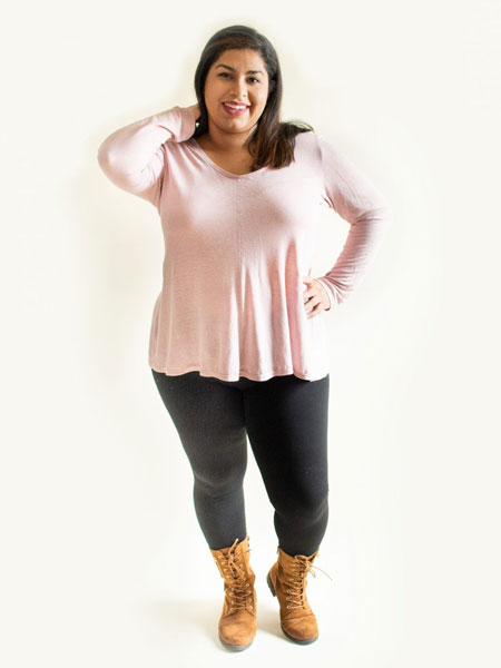 Woman in pink Laela Jeyne Patterns Samantha over black leggings and boots