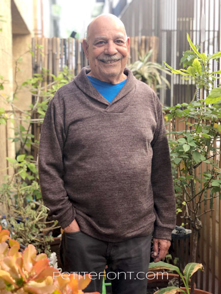 Older bald Latino man in Finlayson sweater