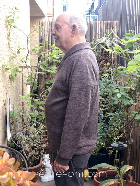 Side profile view of older bald Latino man in Finlayson sweater