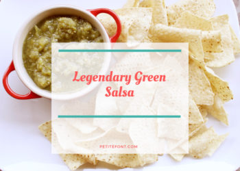 White platter with tortilla chips around a red bowl filled with green salsa with white box overlay and red text that reads Legendary Green Salsa petite font dot com