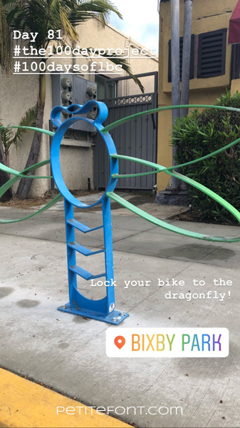Image of dragonfly shaped bike rack on sidewalk. Text at top reads Day 81 hashtag the 100 day project hashtag 100 days of lbc. Text below reads Lock your bike to the dragonfly. Bixby Park. Petite font dot com.