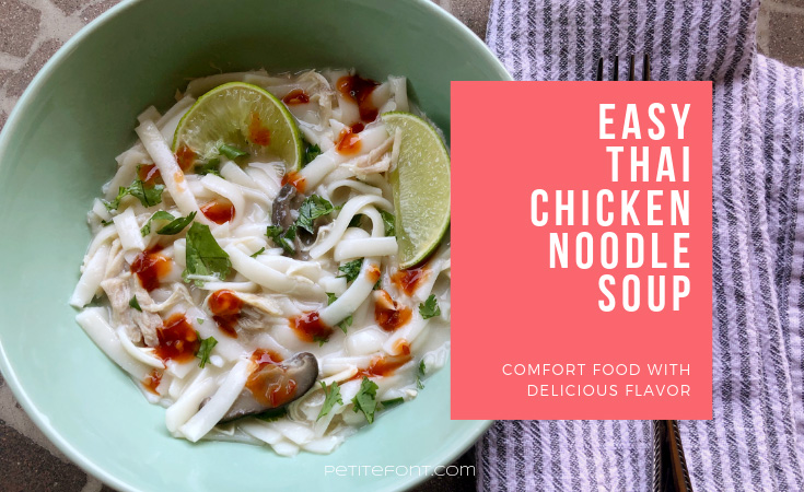 Bowl of easy Thai chicken noodle soup, or tom kha gai, next to a folded striped napkin with white text in a pink box that reads: Easy Thai chicken noodle soup, comfort food with delicious flavor. Petite Font dot com.