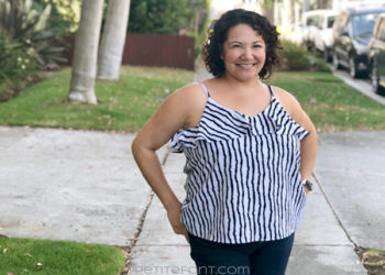 Curly haired Latina woman in a striped ruffled Ogden cami hack facing camera