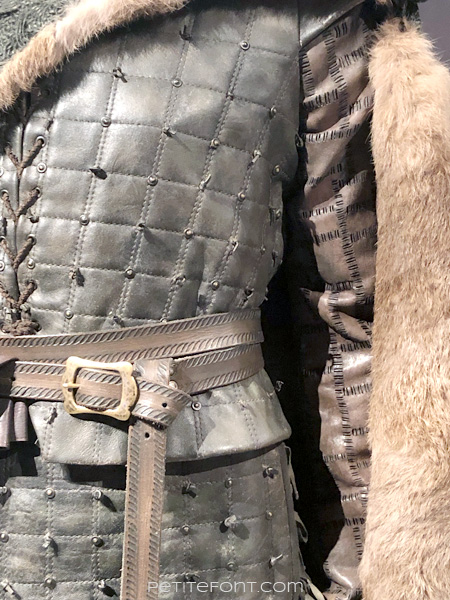 Detail of tunic on mannequin modeling Arya Stark's warrior outfit in the Game of Thrones costumes exhibition at FIDM Museum