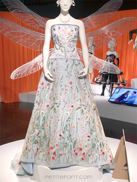 Image of a mannequin wearing a very light blue strapless dress with ornate floral embroidery all around and diaphanous wings on the back, from FIDM's 13th Art of Television Costume Design exhibit