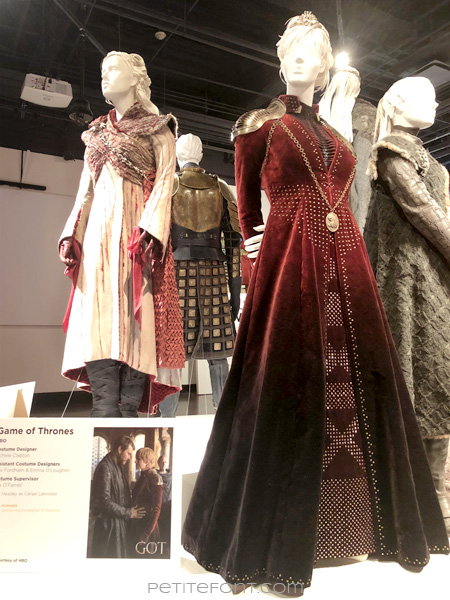 Mannequins modeling Queen Daenerys Targaryen's and Queen Cersei Lannister's outfits in the Game of Thrones costumes exhibition at FIDM Museum