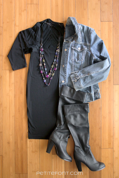 Flatlay image of how to style a jean jacket for a date: black dress, jean jacket, statement necklace, and black thigh high boots