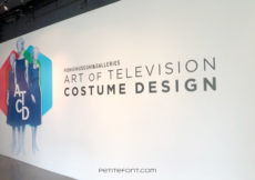 White wall with 3 fashion drawings and large text that reads FIDM Museum & Galleries Art of Television Costume Design