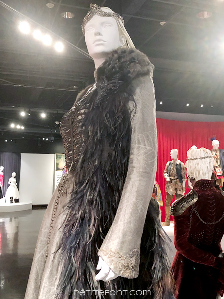 Detail of beaded direwolf shoulder of Sansa Stark's costume in the Game of Thrones costumes exhibition at FIDM Museum