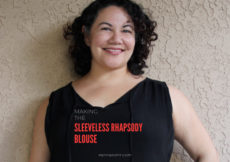 Curly haired Latina woman leaning against beige stucco wall with text overlay that reads Making the Sleeveless Rhapsody Blouse petite font dot com