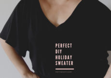 Cropped image of a woman in a black v-neck sweater with short sleeves and light pink text overlay reads Perfet DIY Holiday Sweater, petite font dot com