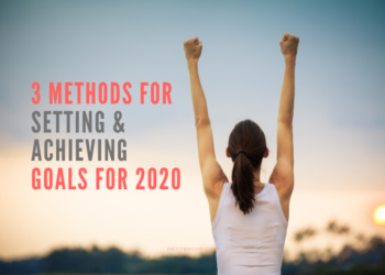 Back view of a woman in a white tank top with her hands up in a victory stance staring at the sunset with text overlay next to her that reads 3 Methods For Setting and Achieving Goals for 2020, petitefont.com