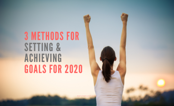 Back view of a woman in a white tank top with her hands up in a victory stance staring at the sunset with text overlay next to her that reads 3 Methods For Setting and Achieving Goals for 2020, petitefont.com