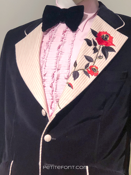 Close up of front embroidery on Eddie Murphy's black velvet tuxedo from My Name is Dolemite, at the 2020 movie costumes exhibit at FIDM