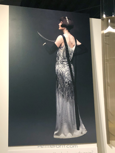 Poster for the Downton Abbey movie showing the back of Michelle Dockery's sequined dress, as seen at the 2020 movie costumes exhibit at FIDM