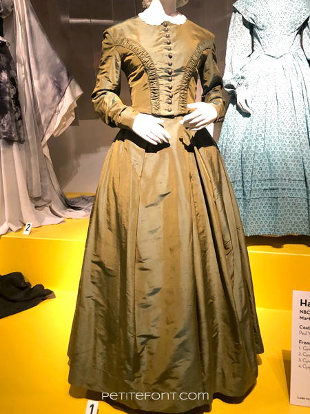Immaculate olive green silk dress from Harriet, at the 2020 movie costumes exhibit at FIDM