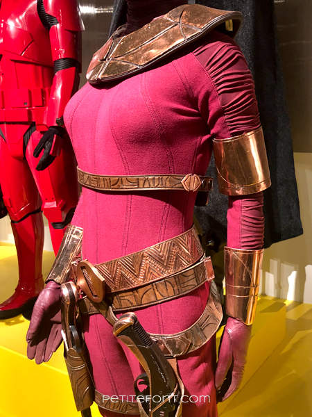 Detail shot of the arm and seaming of the red Zorii Bliss jumpsuit from Star Wars display at the 2020 movie costume exhibit at FIDM