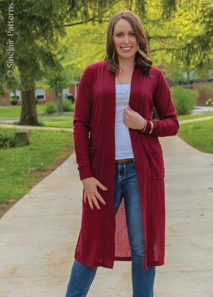 Woman in jeans and a white tee with a long red Harper cardigan over top