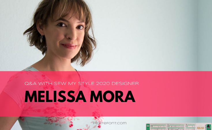 Blank Slate Patterns owner Melissa stands with her hand on her trusty white sewing machine. She is smiling at the camera wearing a blue v-neck t-shirt with pink and red flowers on it. Text overlay reads Q and A with Sew My Style 2020 Designer Melissa Mora.