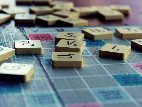 Zoomed in view of Scrabble letters on a game board