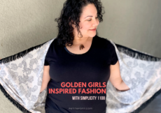 Woman in black with her hands spread holding her peach fringed robe open. She is smiling down at the ground. Text overlay reads "Golden Girls inspired fashion with simplicity 1108"