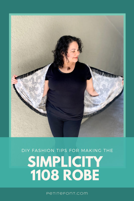 Curly haired woman looking down to the side while holding out the edges of her fringed robe, showing her all black outfit underneath. The picture is inset in a teal frame on a darker turquoise background. Text overlay reads "DIY fashion tips for making the Simplicity 1108 robe"