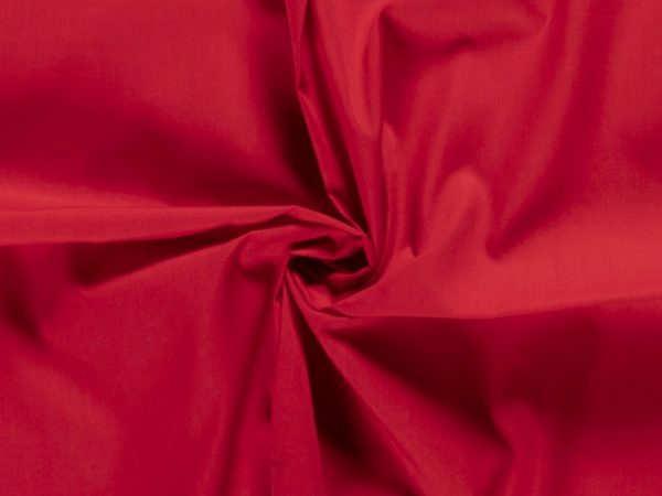 Red poly-cotton poplin fabric bunched together