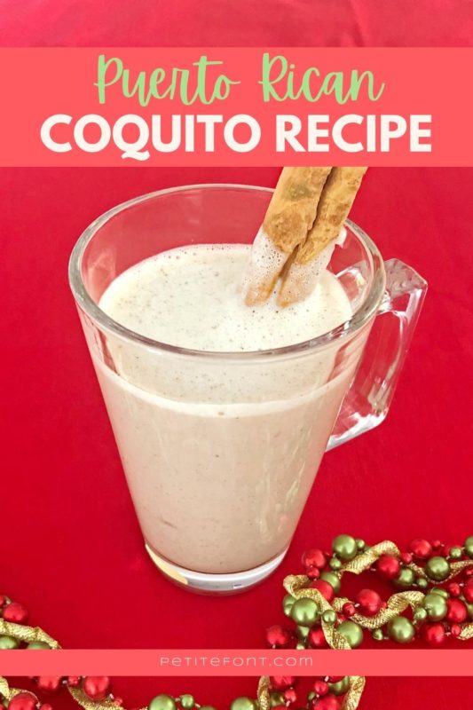 Red background with a clear cup filled with light liquid with a cinnamon stick garnish. A holiday garland snakes around the cup and text overlay reads "Puerto Rican coquito recipe" in a light red box