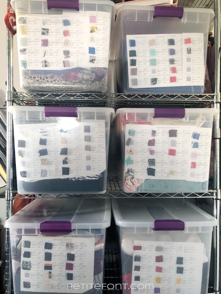 6 clear bins filled with fabric sporting fabric storage inventory sheets stacked in a metal rack