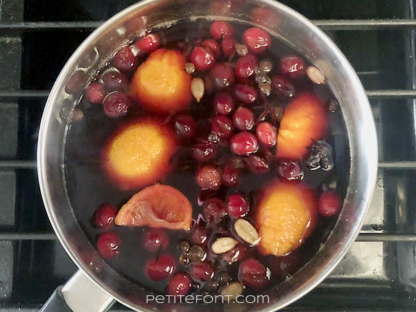 The ingredients for non-alcoholic mulled wine simmering in a pot