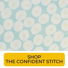 Swatch of white circles on light blue background gauze fabric from The Confident Stitch