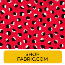 Swatch of red with black and white abstract dots fabric from Fabric.com
